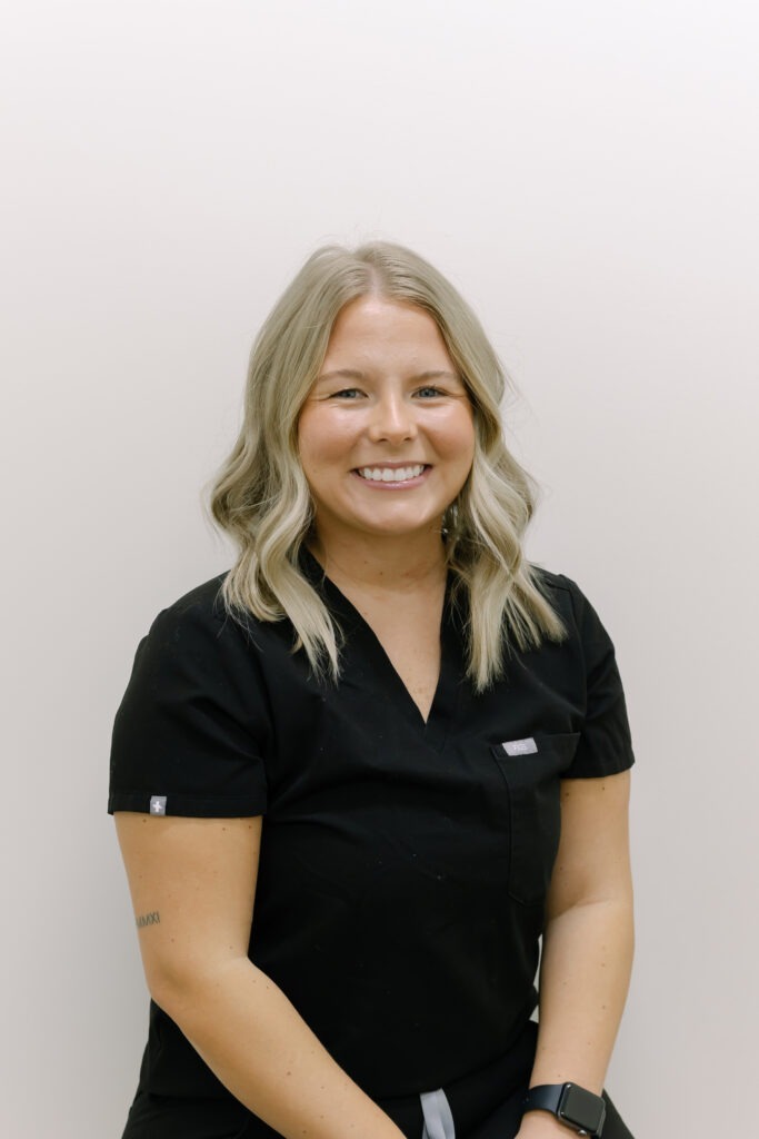 Aubree, clinical assistant at Wiesemann Orthodontics, smiling in professional attire, representing orthodontic care in Russellville, KY, specializing in braces and Invisalign.