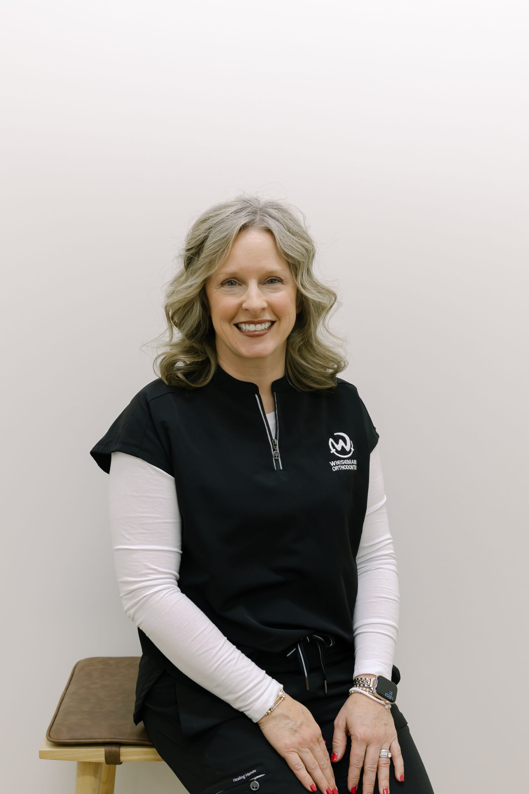 Leslie, office manager at Wiesemann Orthodontics, smiling in black scrubs, representing the friendly team dedicated to orthodontic care in Bowling Green, KY.