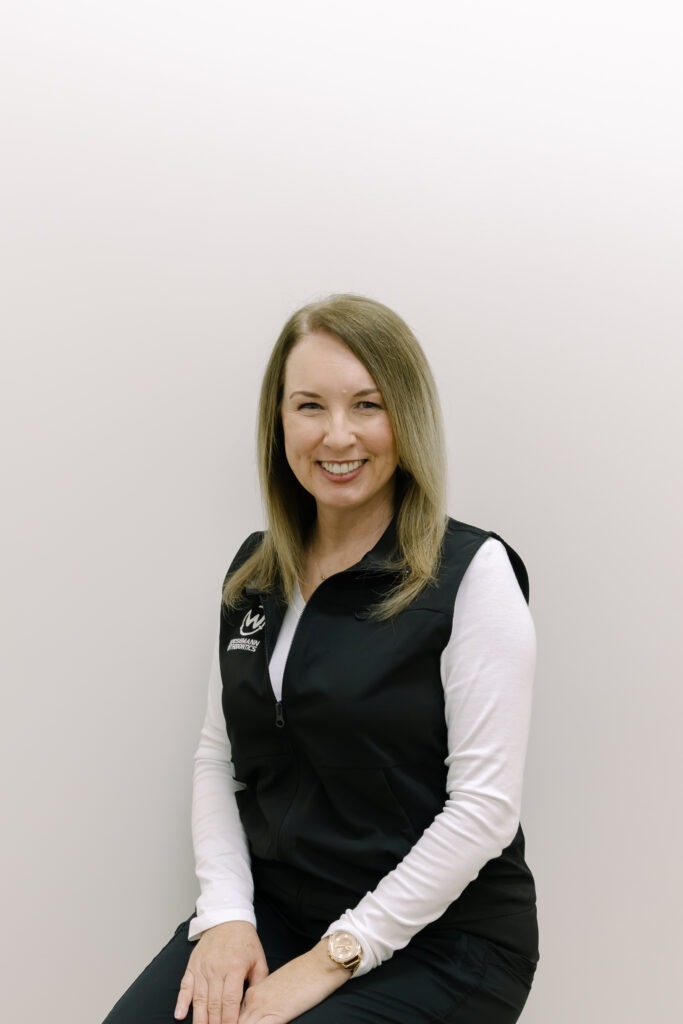 Melissa, Financial Coordinator at Wiesemann Orthodontics, smiling in a professional outfit, showcasing the welcoming team atmosphere in Portland, TN orthodontics.