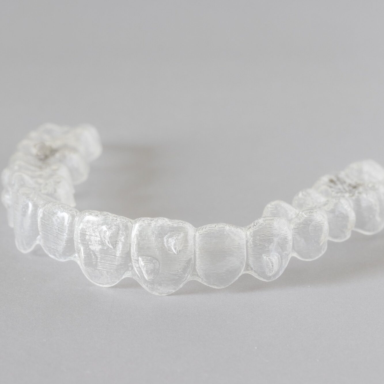 Clear orthodontic retainer worn after braces treatment at Wiesemann Orthodontics in Bowling Green KY